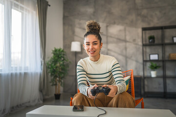 One young woman hold joystick play console video game at home