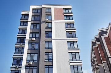 Modern European residential apartment buildings quarter on a sunny day with a blue sky. Abstract architecture, fragment of modern urban geometry