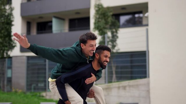 Friends outdoors, having fun, competing, enjoying exercise together. Concept of male friendship, bromance.