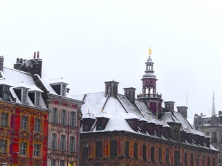 Fototapeta premium Lille, January 2024: Discover Lille, the capital of Flanders, under the snow. Old Lille stock exchange under snow