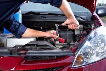 mechanic changing car engine