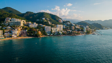 Aerial of Puerto Vallarta Mexico pacific coastline scenic beach at sunset with waterfront hotel...