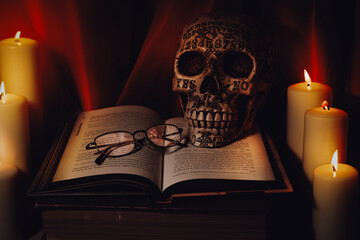 book and candle with skull