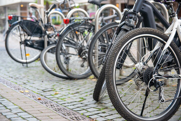 Bicycles parked on the cobbled street in the city.