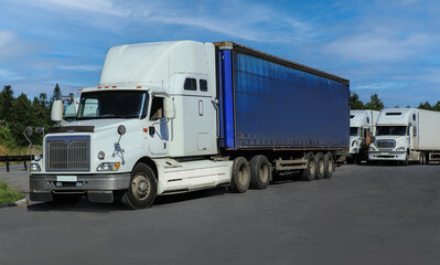trucks with containers in a suburban parking lot