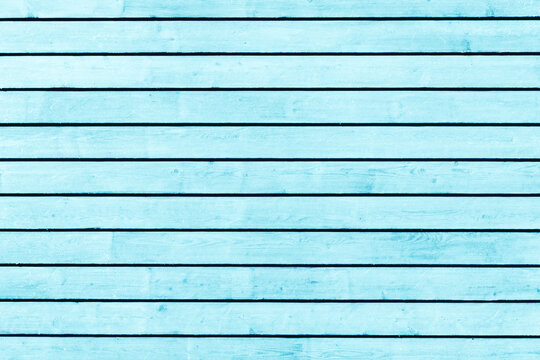 Horizontal blue wood background. Green paint wood texture. Vibrant color plank. Blue color impregnated wood pattern. Bright backdrop. Outdoor woden long stripes. Natural lines pattern.