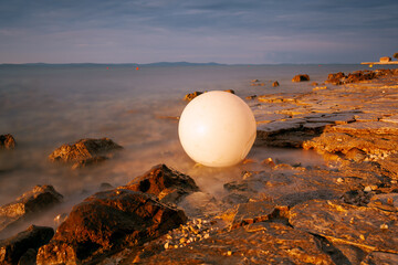 plastic signal buoy on the sea shore. Sunrise over the sea.