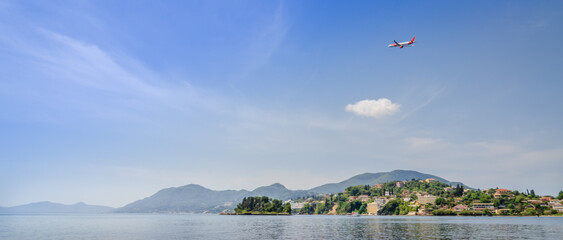 Airplane taking off - Corfu island from Kanoni area during summer with mountainous terrain visible...
