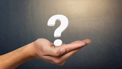 hand holding a white question mark symbol against a background
