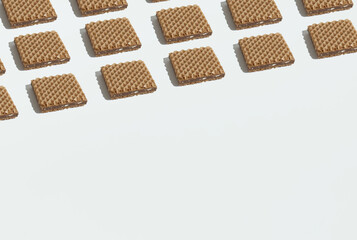 Waffles geometrically laid out on a white background. Copy space. Sweets minimal concept.
