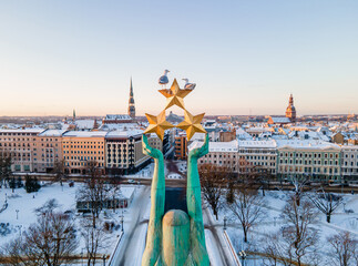 Beautiful sunrise view over Riga by the statue of liberty - Milda in Latvia. The monument of...