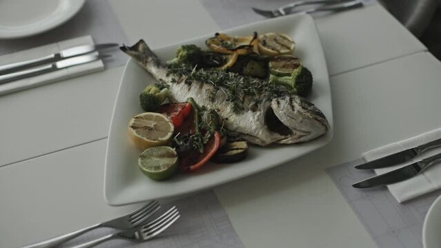 White Plate With Grilled Fish and Fresh Vegetables