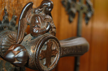 Close-up detail of historic German iron door handle in the shape of a winged angel at Hohenzollern...