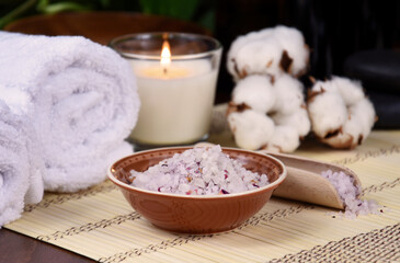 Fototapeta na wymiar Bath salt, white towels and candle on wooden background spa still life stock photo images. Spa and wellness setting with towels, bath salt, cotton and candle photo. Beauty spa treatment composition
