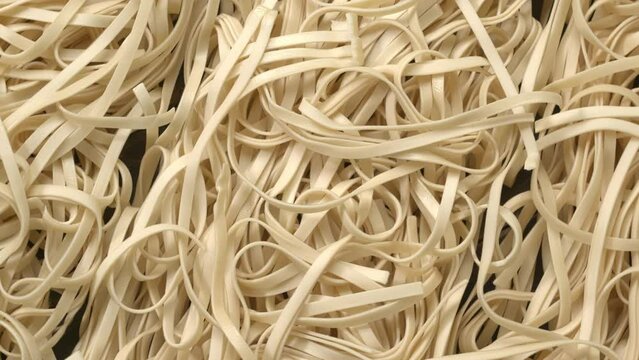 Store-bought uncooked chow mein noodles as abstract food texture. Table spin.  