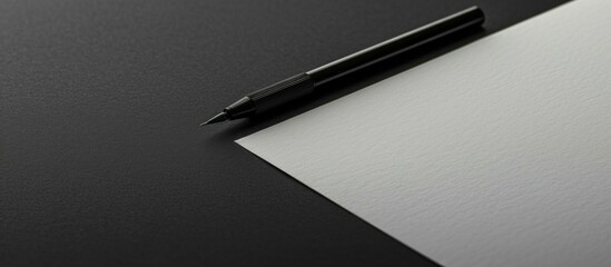 Blank sheet with light writing tool on black surface. - Powered by Adobe