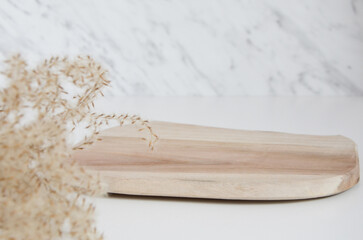 Wooden podium with pampa grass on marble background. Concept scene stage showcase, product,...