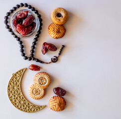 Variety of semolina maamoul cookies displayed with crescent ,star and Ramadan decorations. Traditional Arabic sweets for Eid al Adha and Eid al Fitr celebrations.