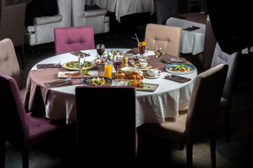 Feast table with a variety of entrees, pizza, porridge, steaks, desserts. General plan