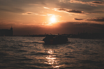 Boat in Venice at sunset. Golden sunset
