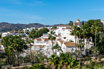 White architecture in the city of Nerja, Spain. Panorama of the city and mountains.