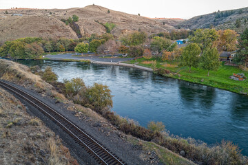 Fototapeta na wymiar Railroad tracks run along the bank of the Deschutes River at Maupin, Oregon, USA