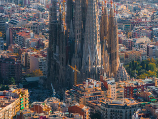 Fototapeta premium Aerial view of Barcelona City Skyline and Sagrada Familia Cathedral at sunset. Residential famous urban grid of Catalonia. Beautiful panorama of Barcelona.