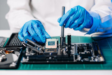The technician repairing the motherboard in the lab with copy space. the concept of computer...