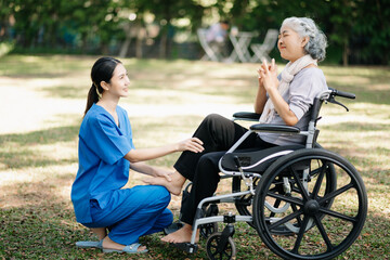 Asian physiotherapist helping elderly woman patient stretching arm during exercise correct with...