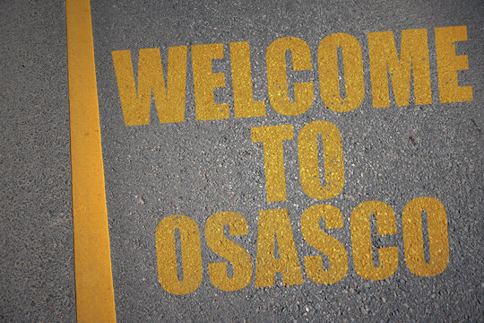 asphalt road with text welcome to osasco near yellow line.