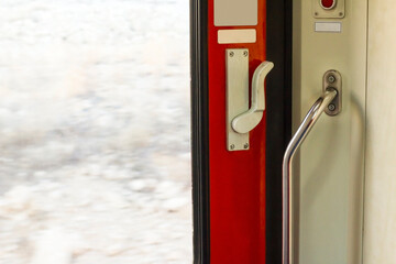 Closed door of a moving train with emergency button,close up taken