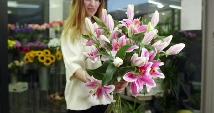 the florist is showing some lilies that have bloomed