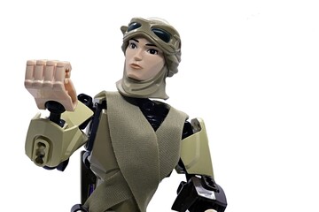 Naklejka premium LEGO Star Wars action figure of Rey Skywalker in desert scavenger outfit checking her fingers.