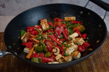 Pepper tofu stir fry in cast iron wok, vegan, gluten free asian