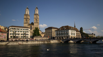 Fototapeta na wymiar River Flowing Through Urban Landscape With Tall Buildings in Zurich, Switzerland