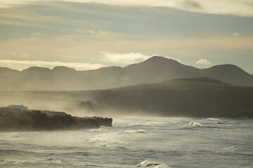 Waves breaking on the north coast of the island of São Miguel in the afternoon, with a lot of fog from the Atlantic Ocean. Sao Miguel Island in the Azores, Portugal