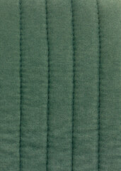 texture of a soft backrest of furniture made of fabric with voluminous vertical stripes close-up