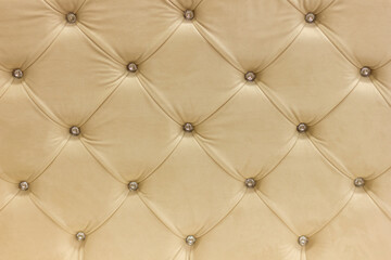 the back of a luxury sofa in retro style with buttons and rhombuses