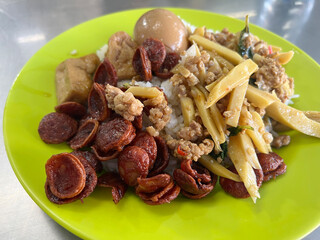 thai street food with fried rice and chicken with vegetables and sausage.