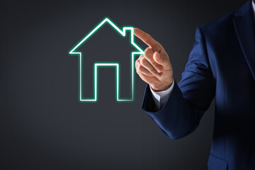 Fototapeta na wymiar Mortgage rate. Man touching illustration of house on virtual screen against dark background, closeup