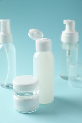 Cosmetic travel kit on light blue background. Bath accessories