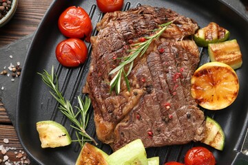 Delicious grilled beef steak and vegetables on table, top view