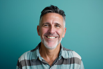 Fototapeta premium A man in a striped shirt is smiling for the camera