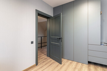 A black interior door ajar in a private house