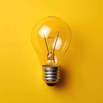 Glowing light bulb, on yellow background. Great idea concept. Copy space for text, generative ai