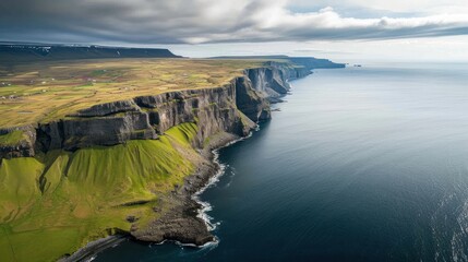  a large body of water next to a lush green hillside covered in lush green grass and a lush green hillside on the side of a cliff face of a large body of water.