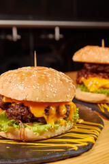 Delicious burger with double meat, caramelized onion, fresh vegetables and potatoes