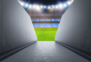 Tunnel in stadium with green soccer field © phonlamaiphoto