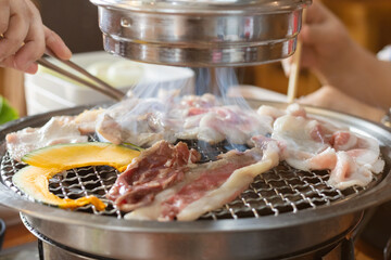 Grilled meat and vegetables being grilled on barbecue grill in a restaurant. 