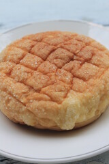 Bread sprinkled with granulated sugar in a plate on the table